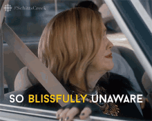 A woman turning her head and saying SO BLISSFULLY UNAWARE