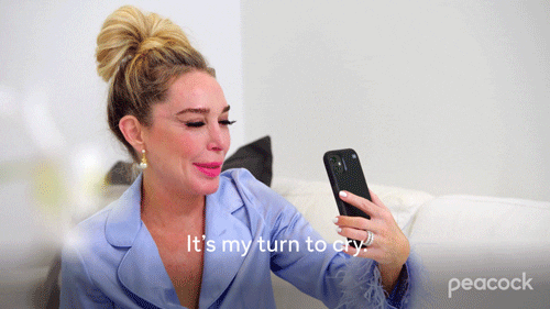 A person talking into a phone saying 'It's my turn to cry'