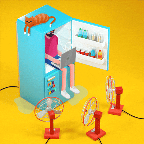 Man sitting in freezer with laptop, sipping soda, with 3 fans blasting