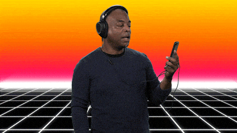 LeVar Burton with headphones on, looking at a phone, and saying "amazing content"