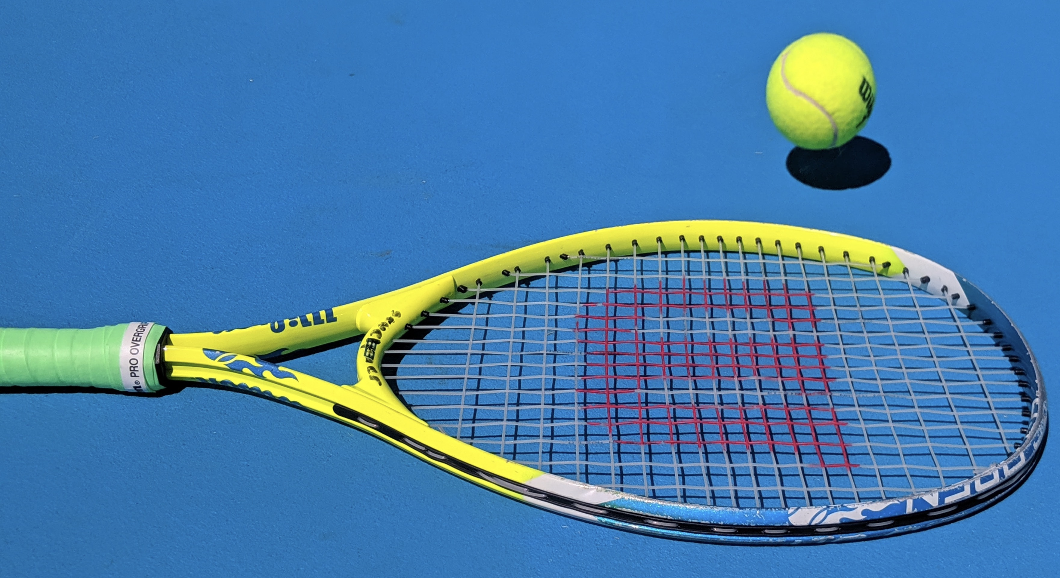 a tennis racket and a tennis ball on a blue background