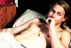 Charlie Hunnam in bed smiling