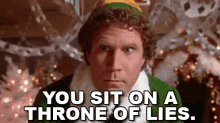 An adult in an elf costume saying YOU SIT ON A THRONE OF LIES