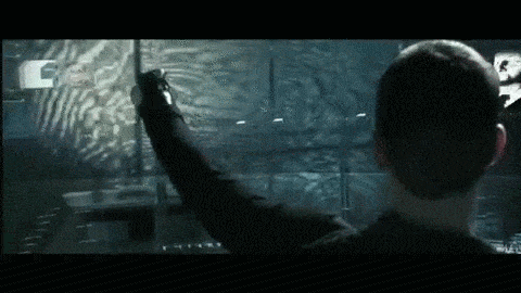 A man uses gesture technology to manipulate a computer screen in Minority Report