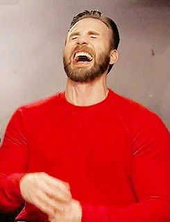 Chris Evans, a white hottie wearing a red sweater, laughing