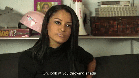 Claudia Jordan, sitting on a couch and saying "Oh, look at you throwing shade"